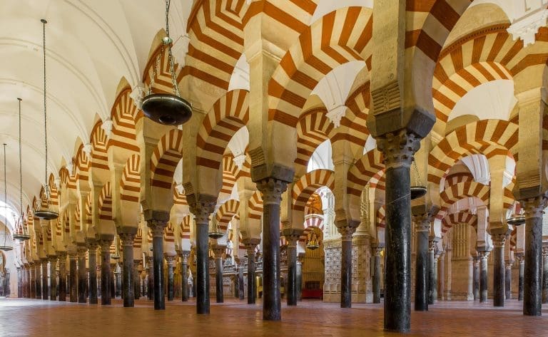 Arches within the historic Mosque-Cathedral of Córdoba, showcasing Islamic architecture.